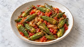 Gombos entiers rôtis aux tomates et oignon dans un plat bas