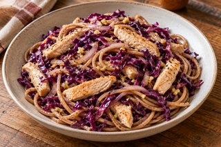 Wholegrain spaghetti with purple red cabbage ribbons and pale browned turkey strips in a thin soy sauce